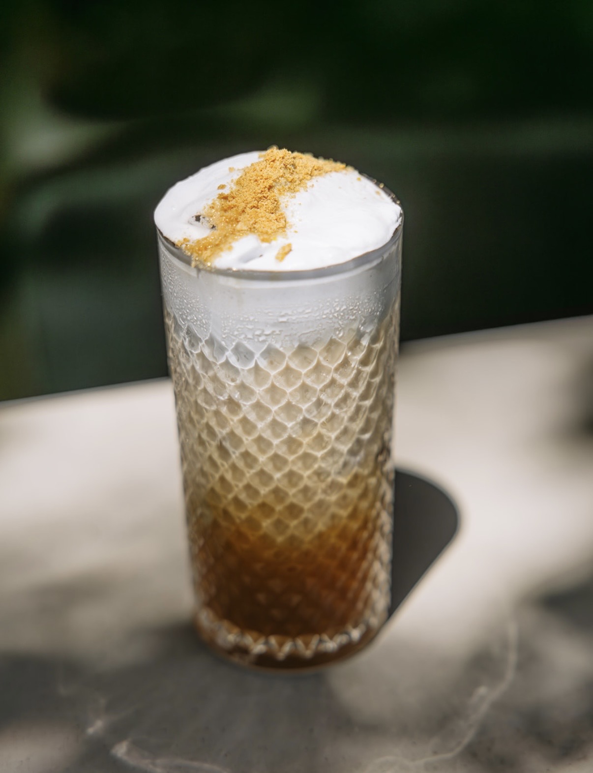 Iced espresso drink with cold foam and cookie crumble from the Brü Avl coffee bar